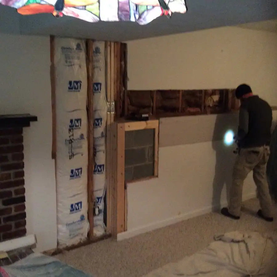 Restoration technician inspecting water damage in Chatham